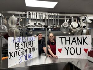 kitchen team holding posters